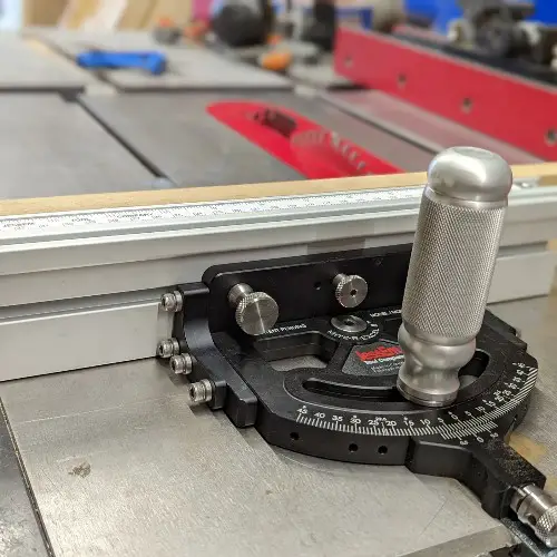 Inspect the miter gauge to see if it is tight and positioned correctly